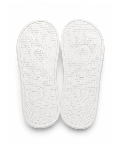 Ivory fluffy slippers with slip resistant soles.